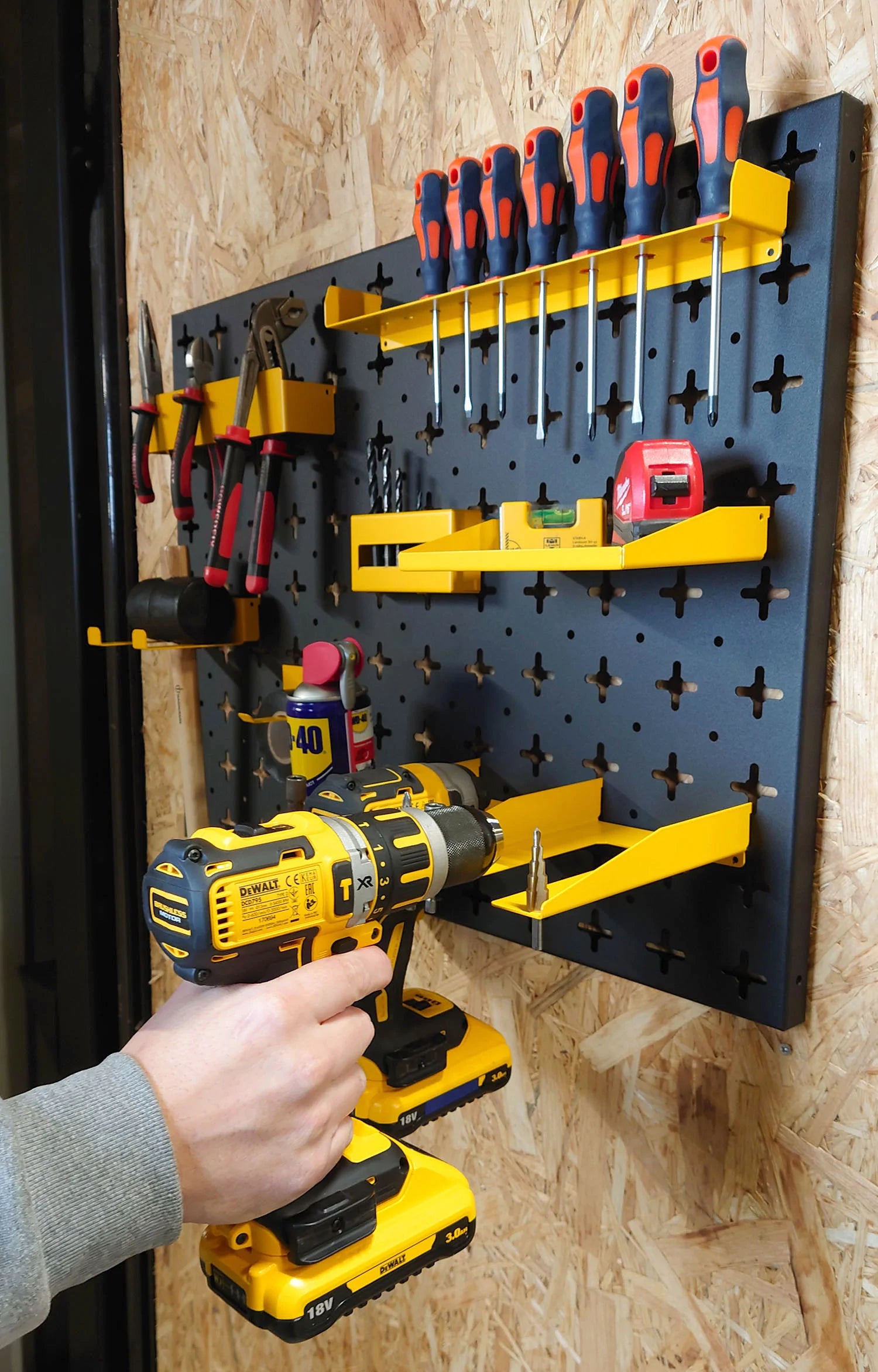 Man Placing Drill onto Nukeson Tool Wall